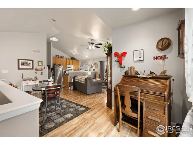 a living room with furniture kitchen view and a chandelier