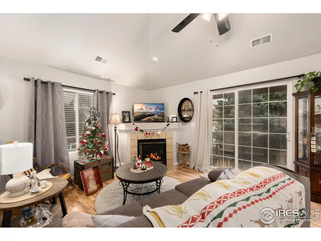 a living room with furniture a fireplace and a television
