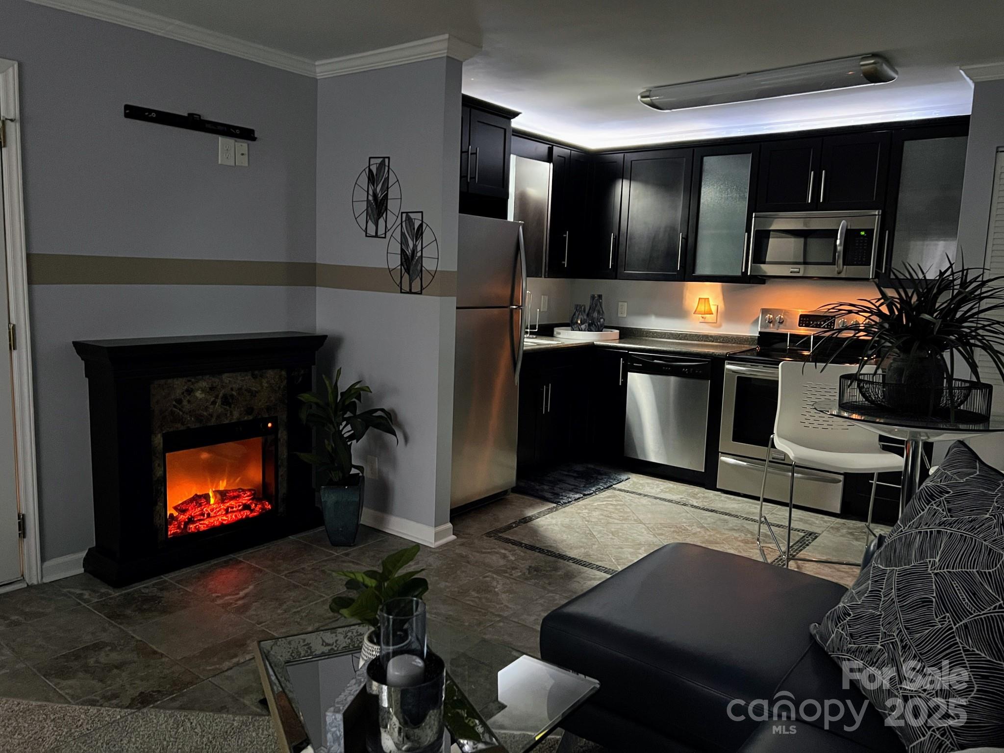 109 Stroupe Road, Unit E Gastonia, NC 28056 - Photo 11 of 25 a living room with furniture a fireplace and kitchen view