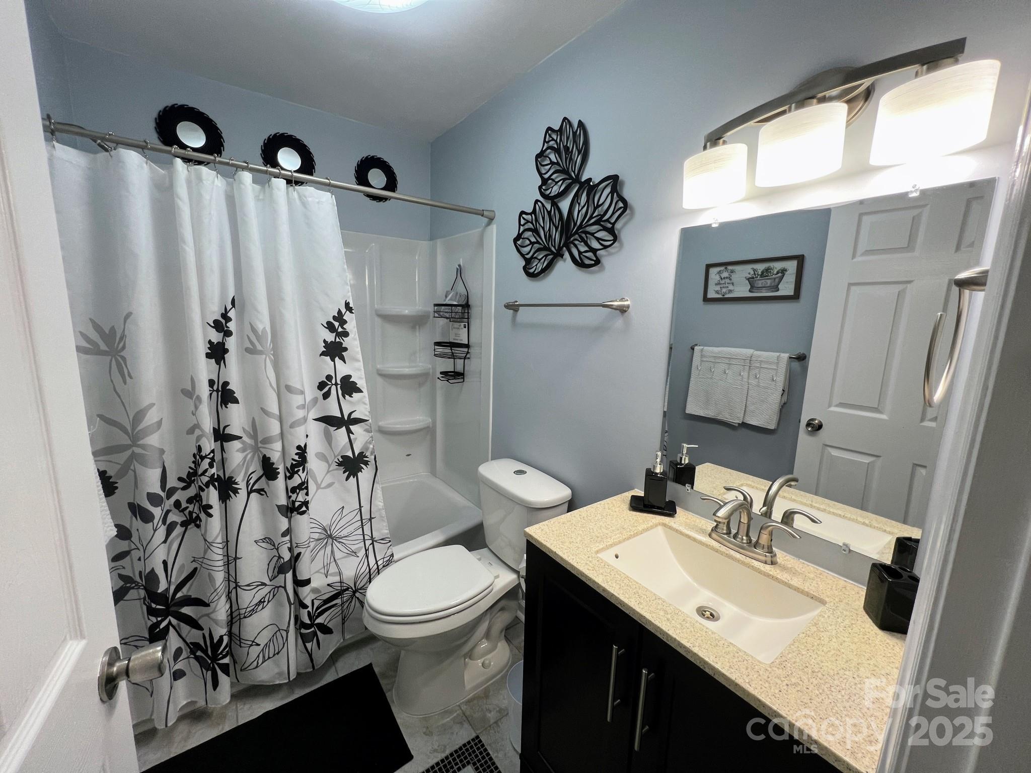 109 Stroupe Road, Unit E Gastonia, NC 28056 - Photo 16 of 25 a bathroom with a sink toilet and shower