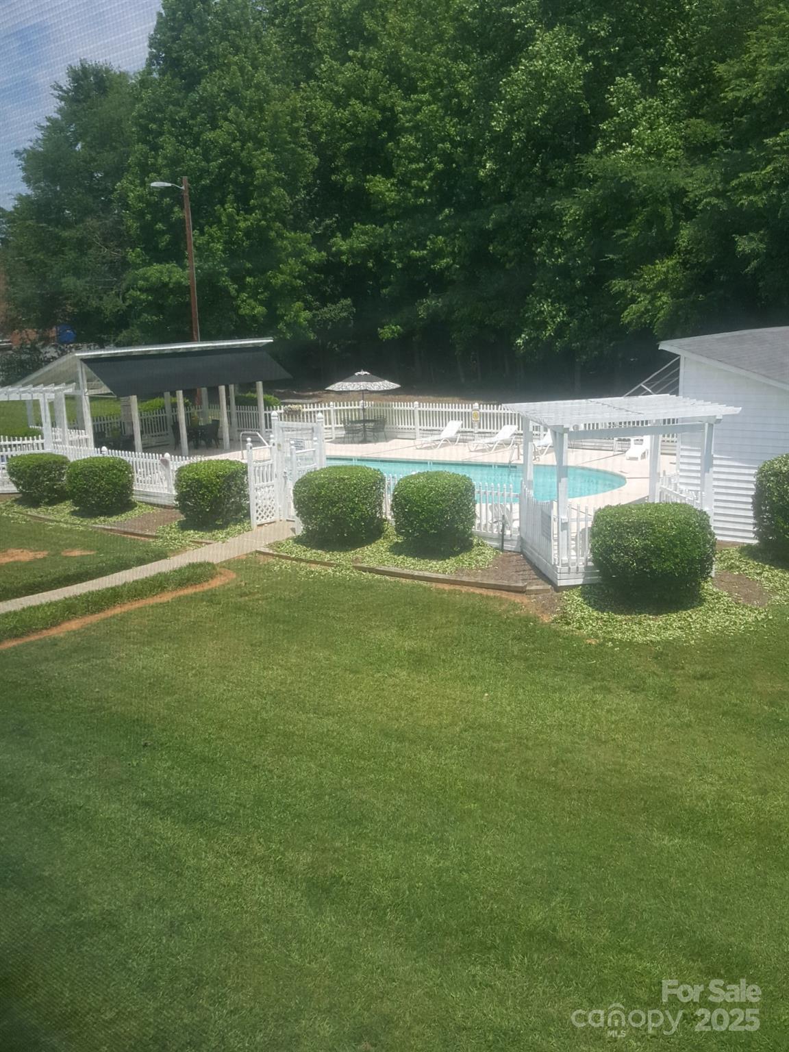 109 Stroupe Road, Unit E Gastonia, NC 28056 - Photo 7 of 25 a view of a swimming pool with a yard