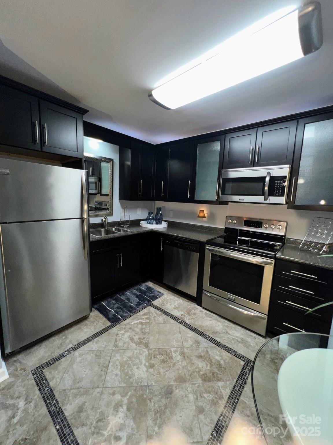 109 Stroupe Road, Unit E Gastonia, NC 28056 - Photo 8 of 25 a kitchen with granite countertop stainless steel appliances and wooden cabinets
