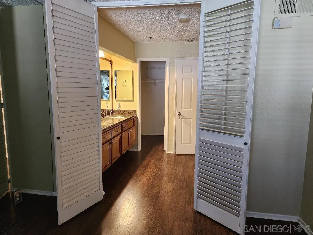 5705 Friars Road, Unit 22 San Diego, CA 92110 - Photo 13 of 38 a view of a hallway with wooden floor and staircase