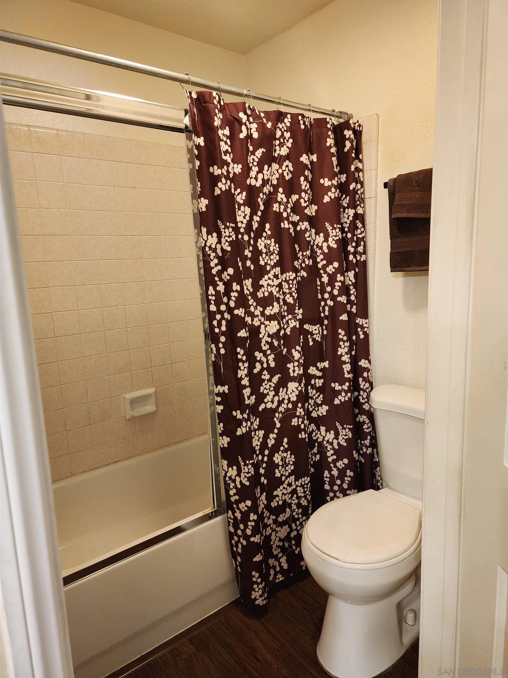 5705 Friars Road, Unit 22 San Diego, CA 92110 - Photo 15 of 38 a bathroom with a toilet and a shower curtain
