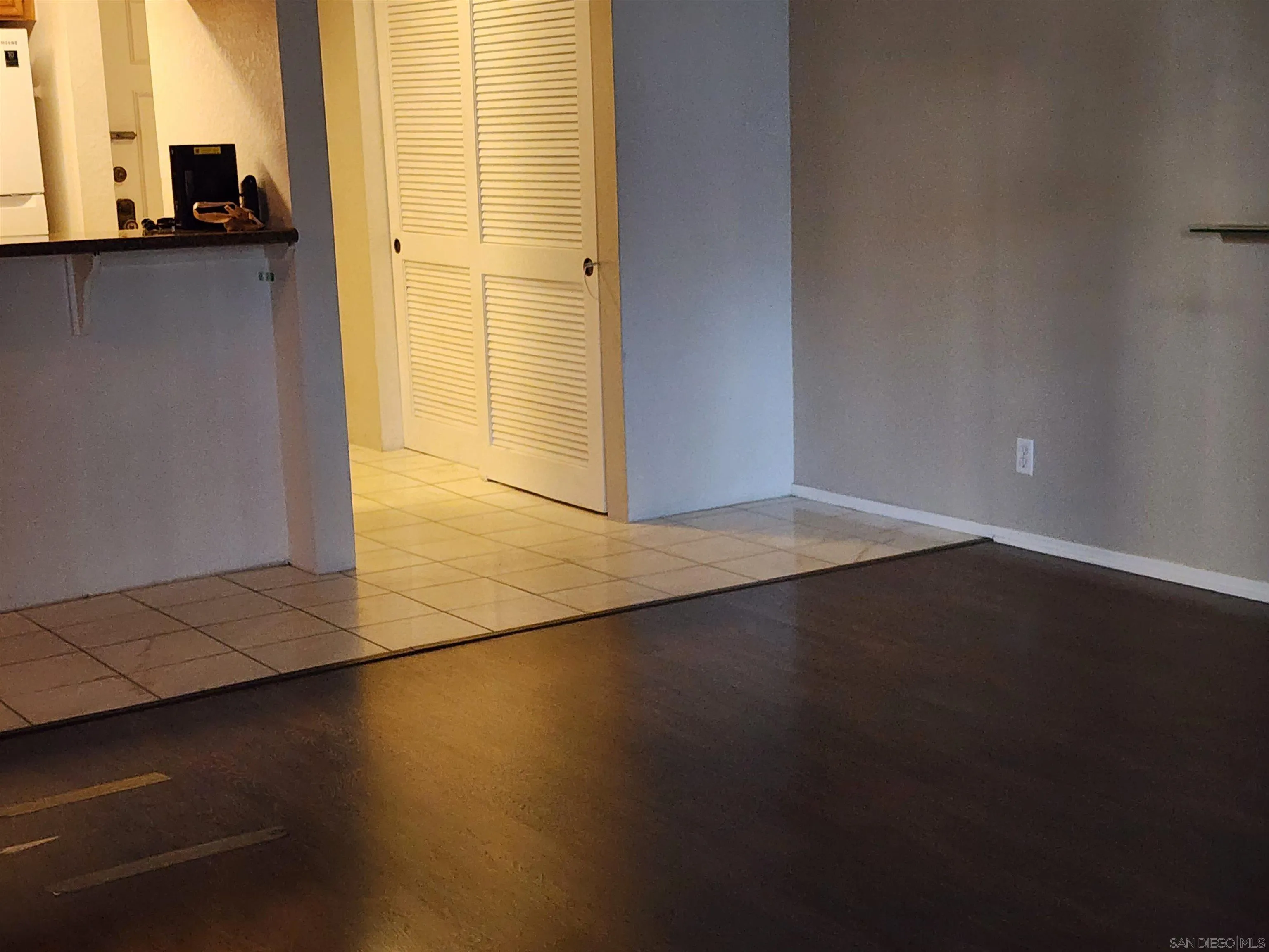5705 Friars Road, Unit 22 San Diego, CA 92110 - Photo 16 of 38 an empty room with wooden floor and windows