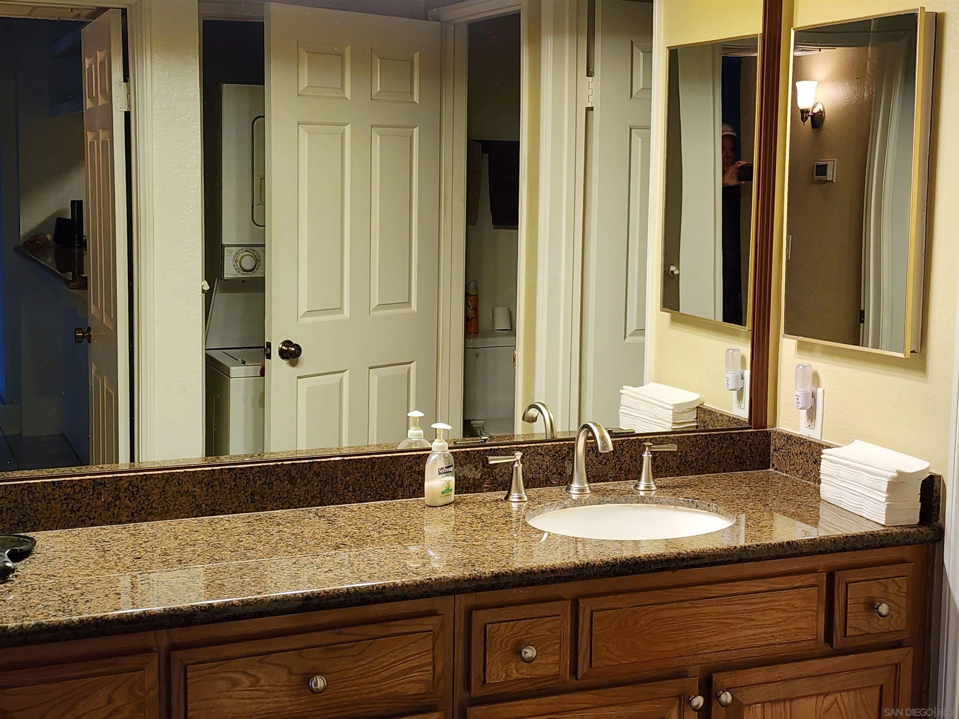 5705 Friars Road, Unit 22 San Diego, CA 92110 - Photo 8 of 38 a bathroom with a granite countertop sink and a mirror