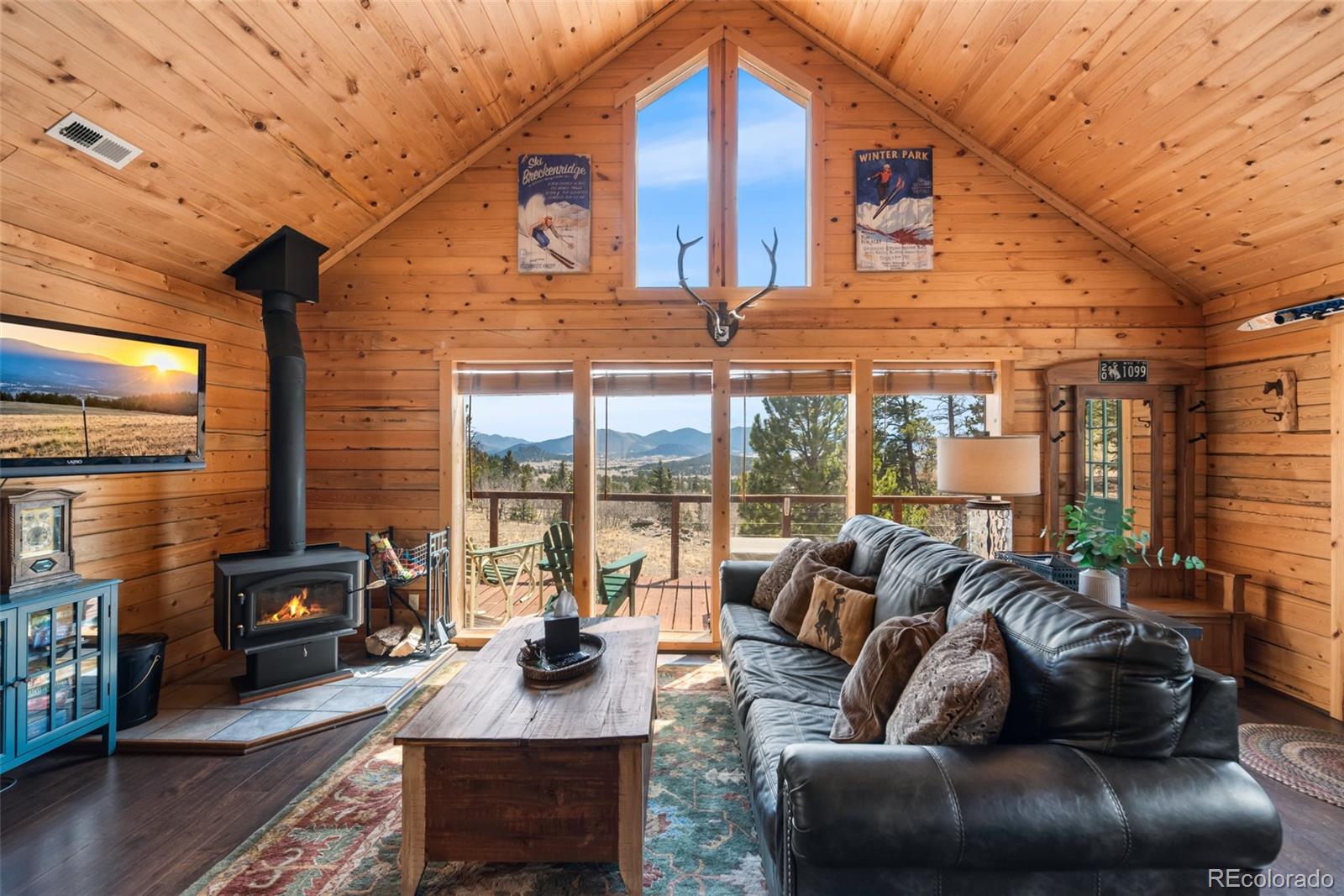 858 Red Cloud Road Jefferson, CO 80456 - Photo 12 of 32 a living room with furniture and a floor to ceiling window