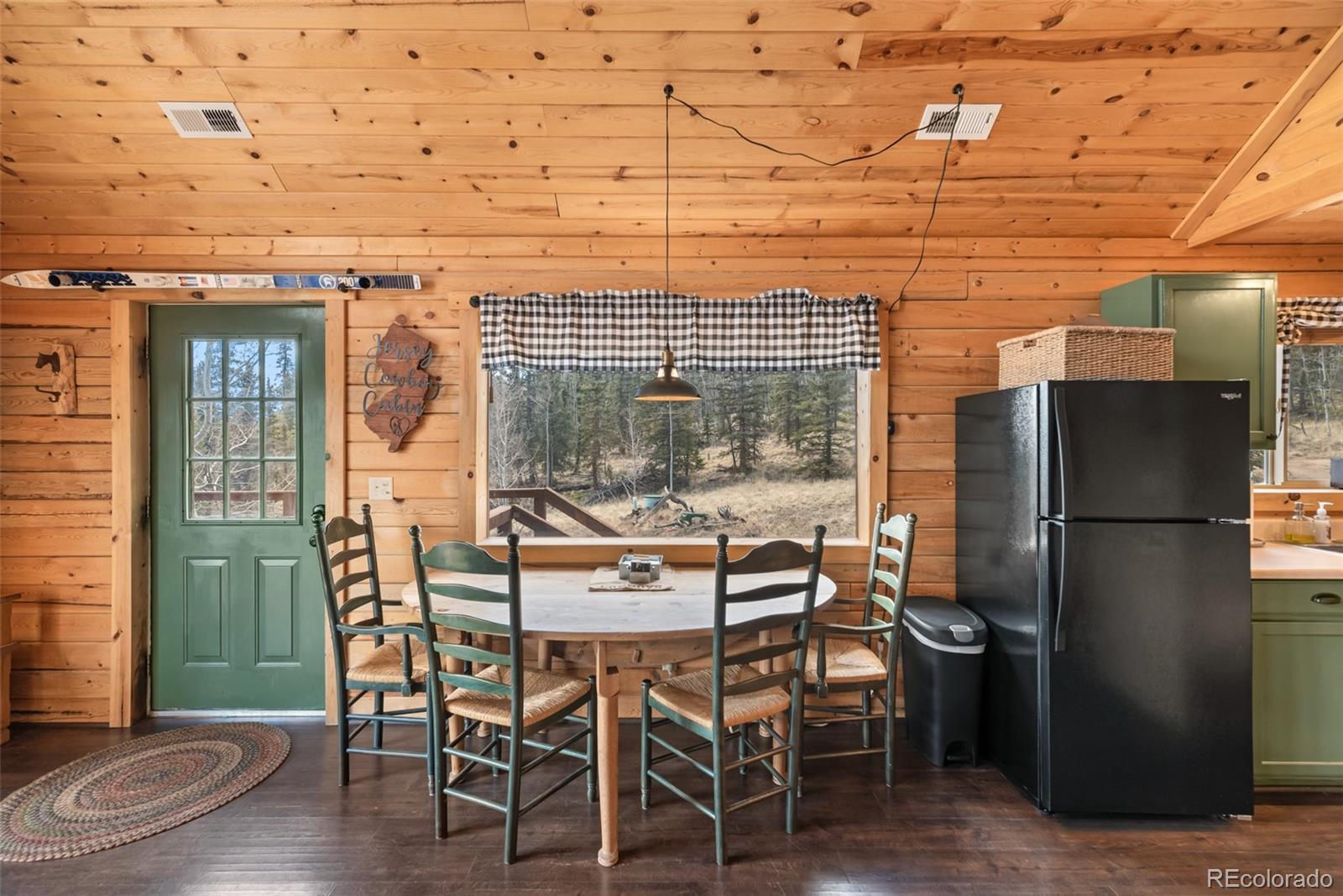 858 Red Cloud Road Jefferson, CO 80456 - Photo 19 of 32 a dining room with furniture and wooden floor