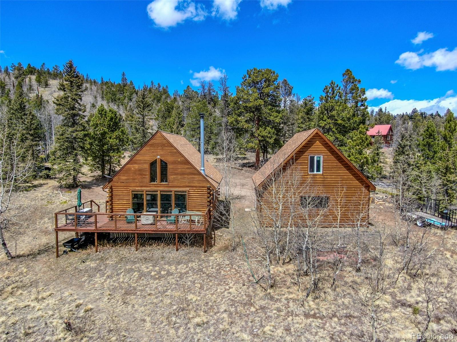 858 Red Cloud Road Jefferson, CO 80456 - Photo 2 of 32 a front view of a house with a yard and mountain view