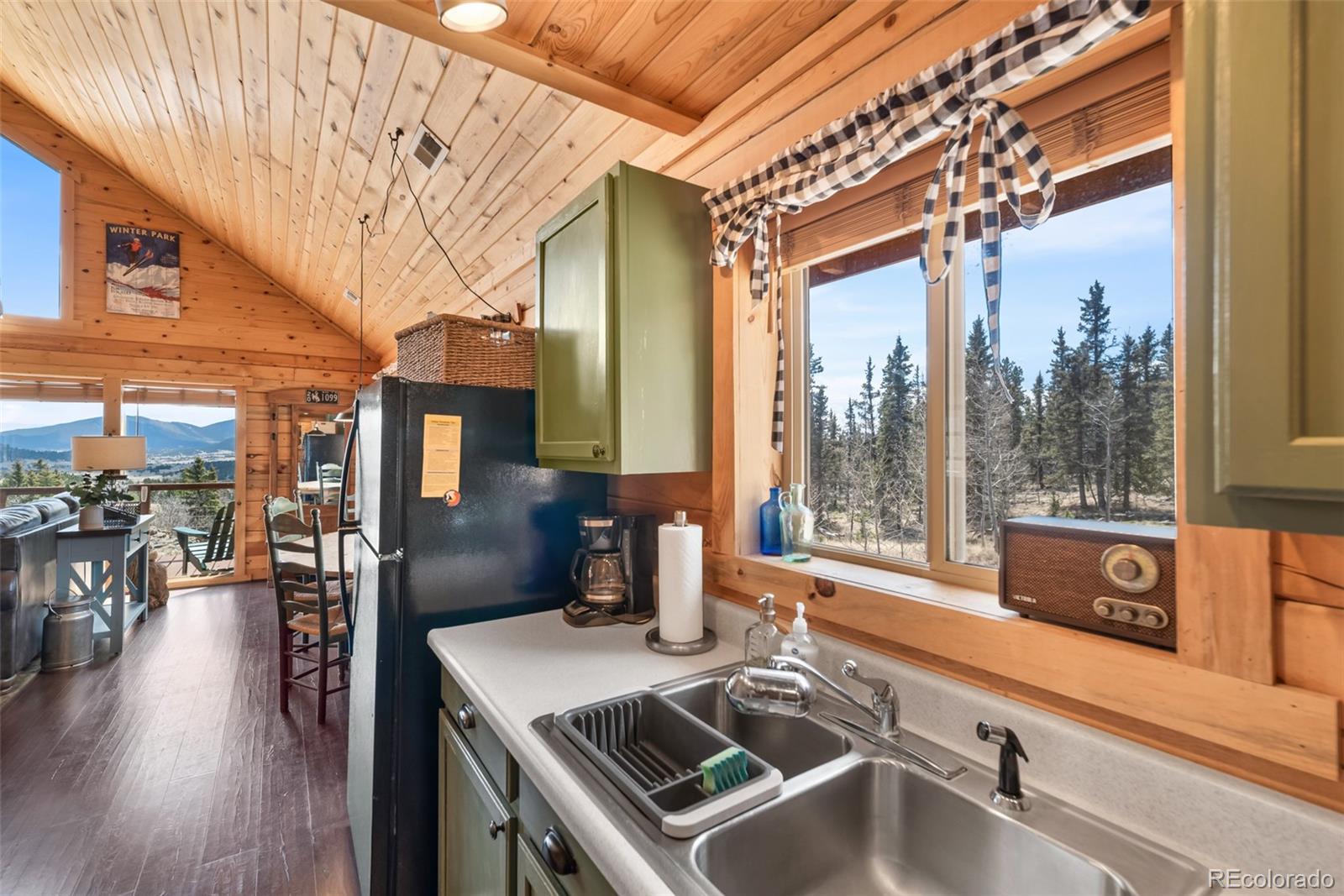 858 Red Cloud Road Jefferson, CO 80456 - Photo 21 of 32 a kitchen with a stove a sink and a wooden cabinets