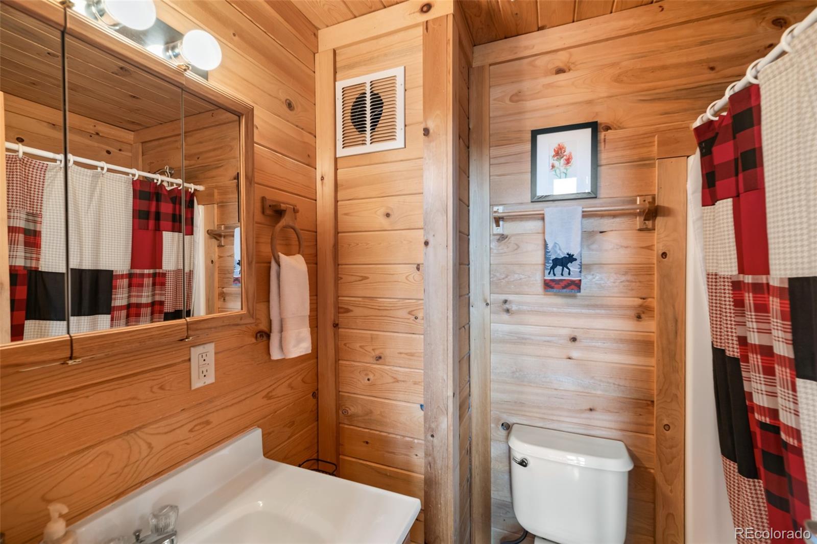858 Red Cloud Road Jefferson, CO 80456 - Photo 24 of 32 a bathroom with a toilet and a shower