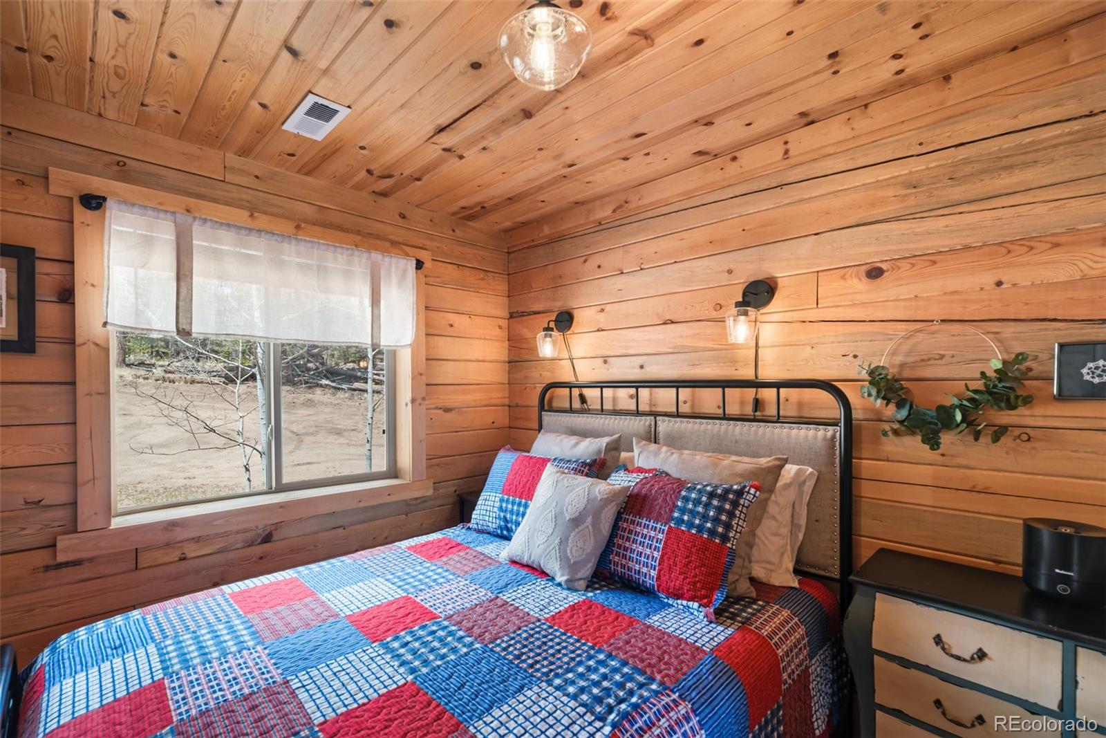 858 Red Cloud Road Jefferson, CO 80456 - Photo 28 of 32 a bedroom with a bed next to a window