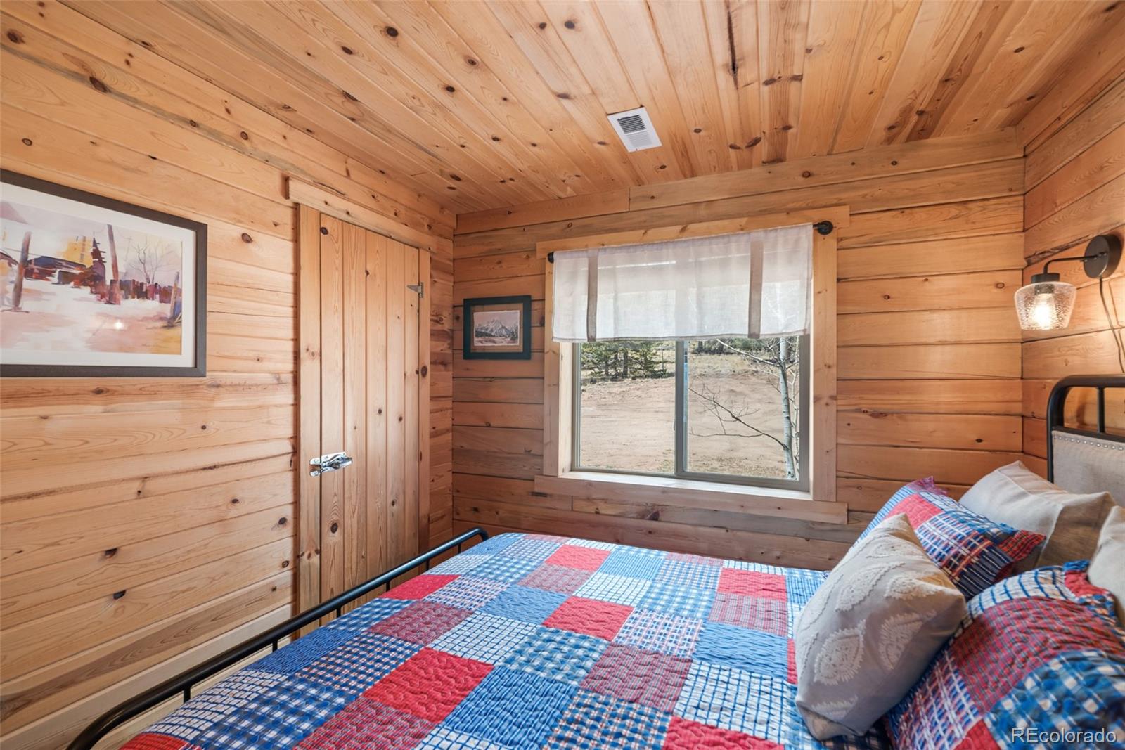 858 Red Cloud Road Jefferson, CO 80456 - Photo 29 of 32 a bedroom with a bed and a window
