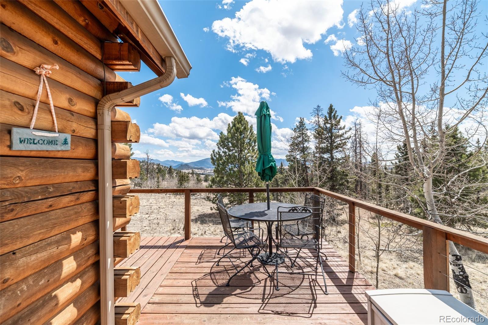 858 Red Cloud Road Jefferson, CO 80456 - Photo 8 of 32 a view of a balcony with chairs and wooden floor