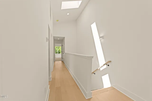 a spacious bedroom with a bed and painting on the wall