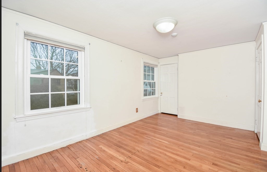 77 Hagen Road Newton, MA 02459 - Photo 16 of 18 a view of empty room with wooden floor and fan