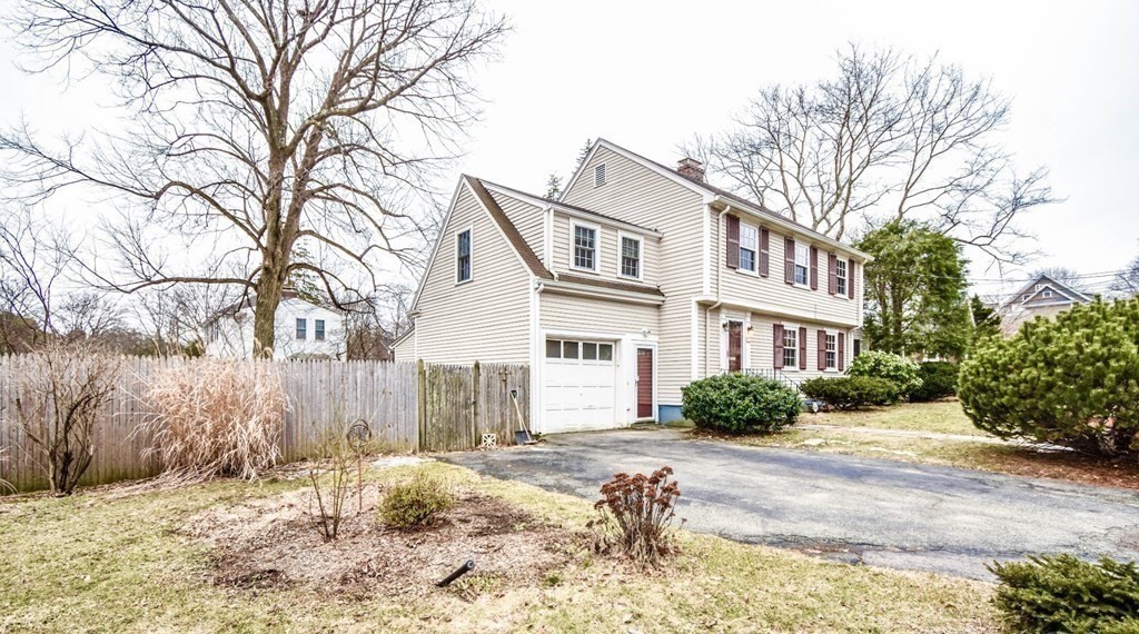 77 Hagen Road Newton, MA 02459 - Photo 2 of 18 a front view of a house with a yard covered in snow