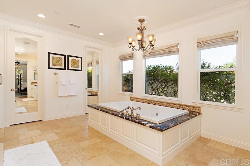6301 Allston Street Carlsbad, CA 92009 - Photo 45 of 73 a white bath tub sitting in a room next to a window