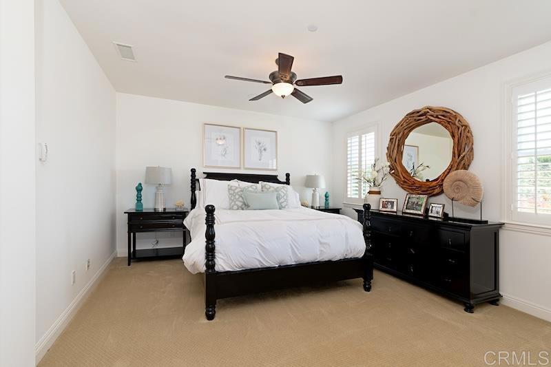 6301 Allston Street Carlsbad, CA 92009 - Photo 53 of 73 a bedroom with a bed and a chandelier