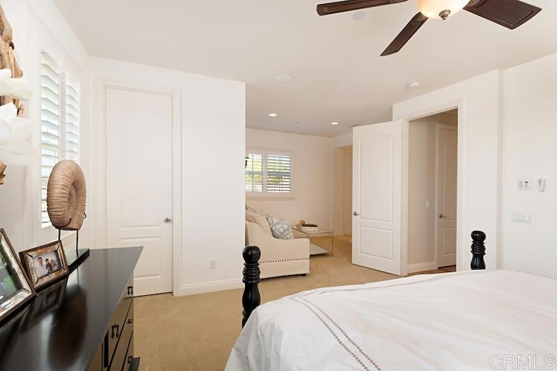 6301 Allston Street Carlsbad, CA 92009 - Photo 54 of 73 a bedroom with a bed and chandelier