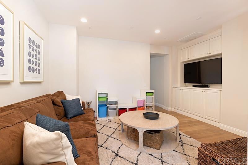 6301 Allston Street Carlsbad, CA 92009 - Photo 58 of 73 a living room with furniture and a flat screen tv