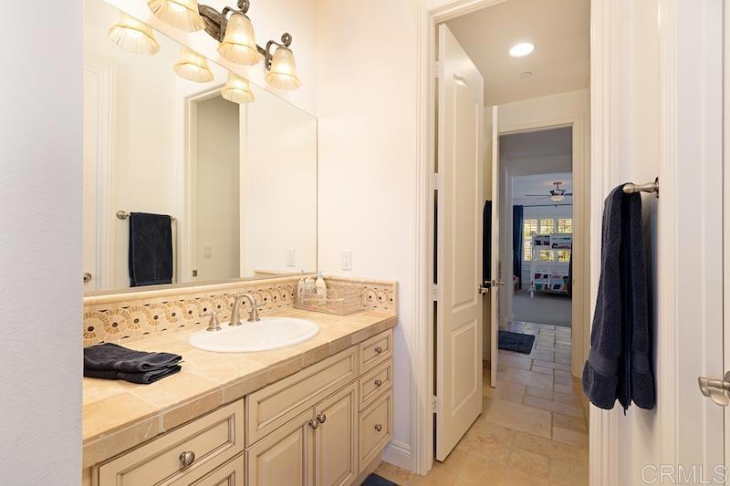 6301 Allston Street Carlsbad, CA 92009 - Photo 60 of 73 a en suite bathroom with a sink double vanity and a mirror