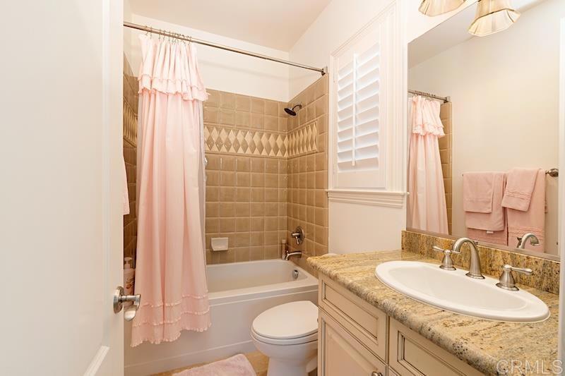 6301 Allston Street Carlsbad, CA 92009 - Photo 63 of 73 a bathroom with a granite countertop sink toilet and shower