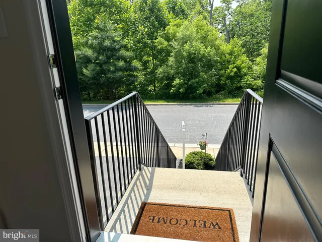 a view of a room with wooden floor and window