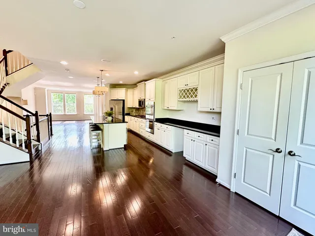 a view of a house with wooden fence and a yard