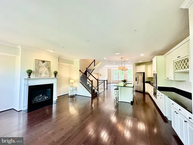 a bathroom with a granite countertop bathtub sink vanity mirror and toilet