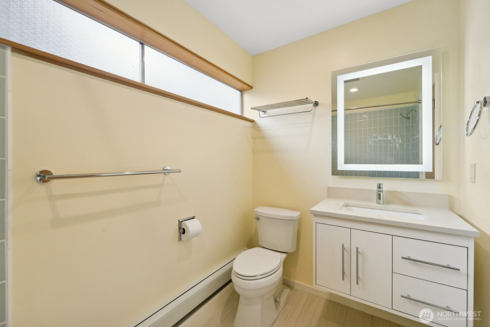 2148 North 115th Street Seattle, WA 98133 - Photo 15 of 26 a bathroom with a sink a toilet and shower