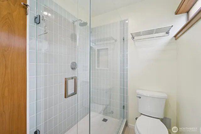 a bathroom with a shower and a toilet