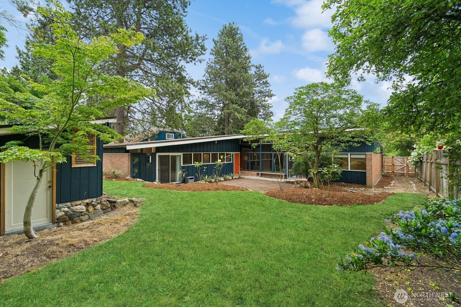 2148 North 115th Street Seattle, WA 98133 - Photo 25 of 26 a view of a backyard with table and chairs potted plants and large tree