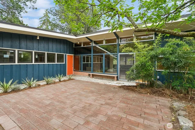 a backyard of a house with lots of green space and outdoor seating