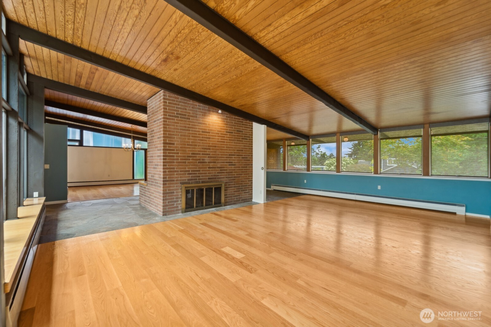 2148 North 115th Street Seattle, WA 98133 - Photo 5 of 26 a view of an empty room with a window and wooden floor