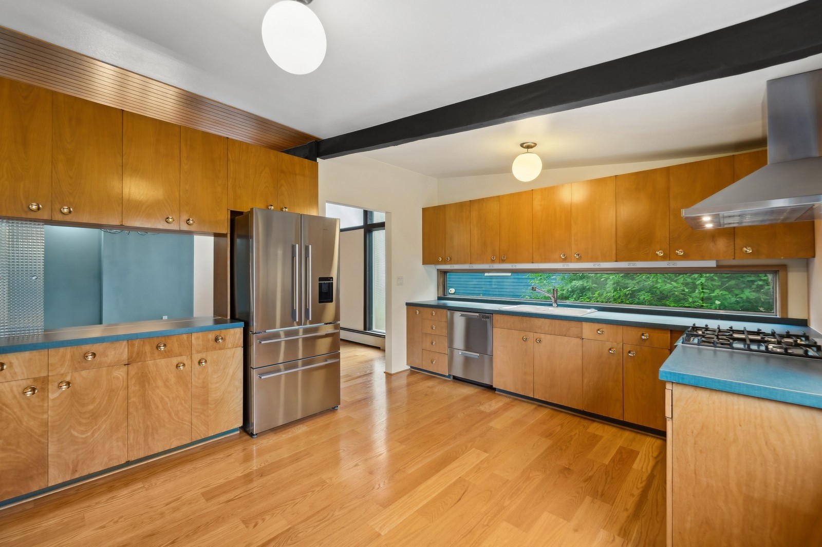 2148 North 115th Street Seattle, WA 98133 - Photo 6 of 26 a kitchen with stainless steel appliances granite countertop a refrigerator a stove and a wooden floors