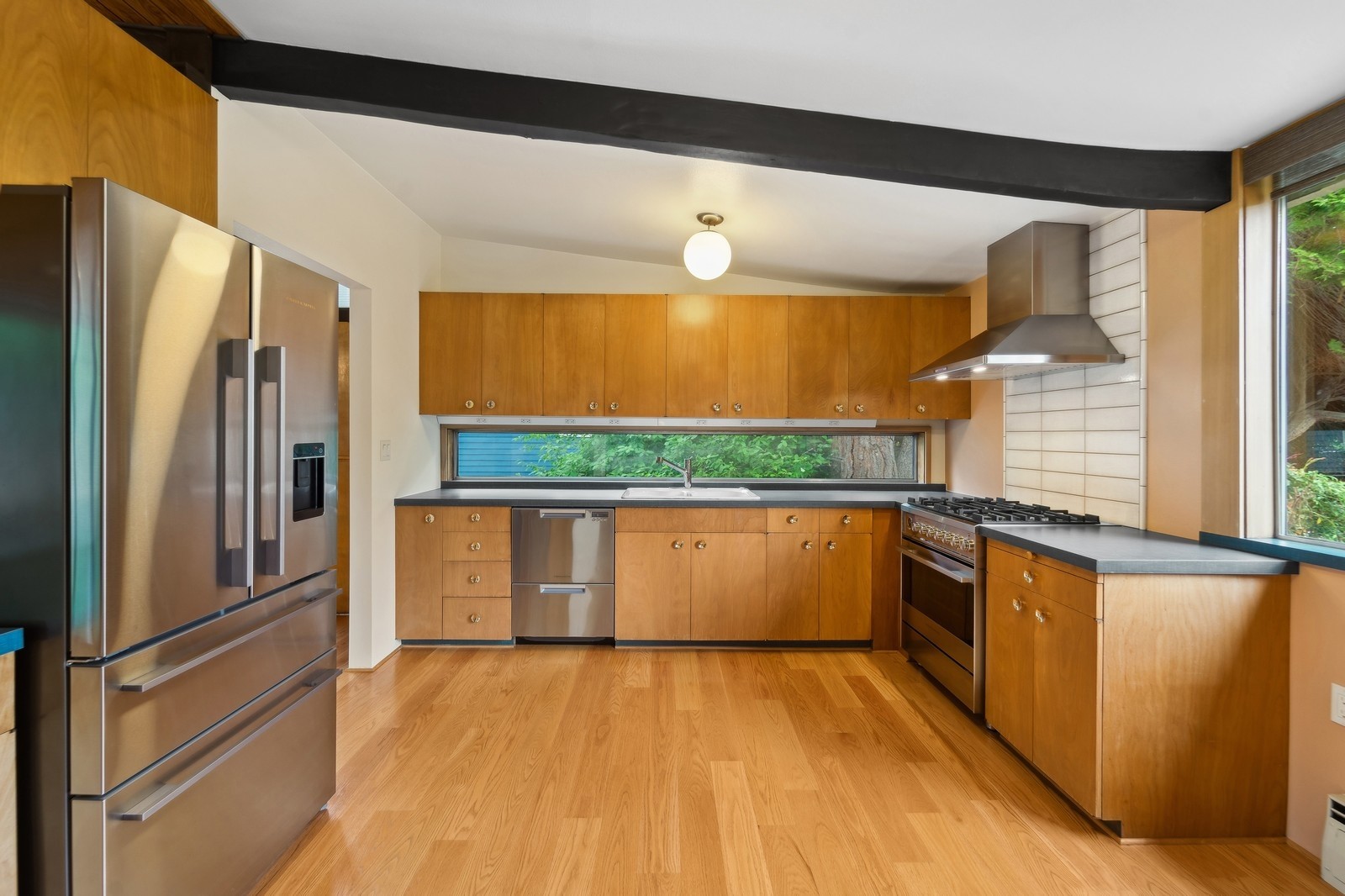2148 North 115th Street Seattle, WA 98133 - Photo 8 of 26 a kitchen with stainless steel appliances granite countertop a refrigerator a sink and a stove