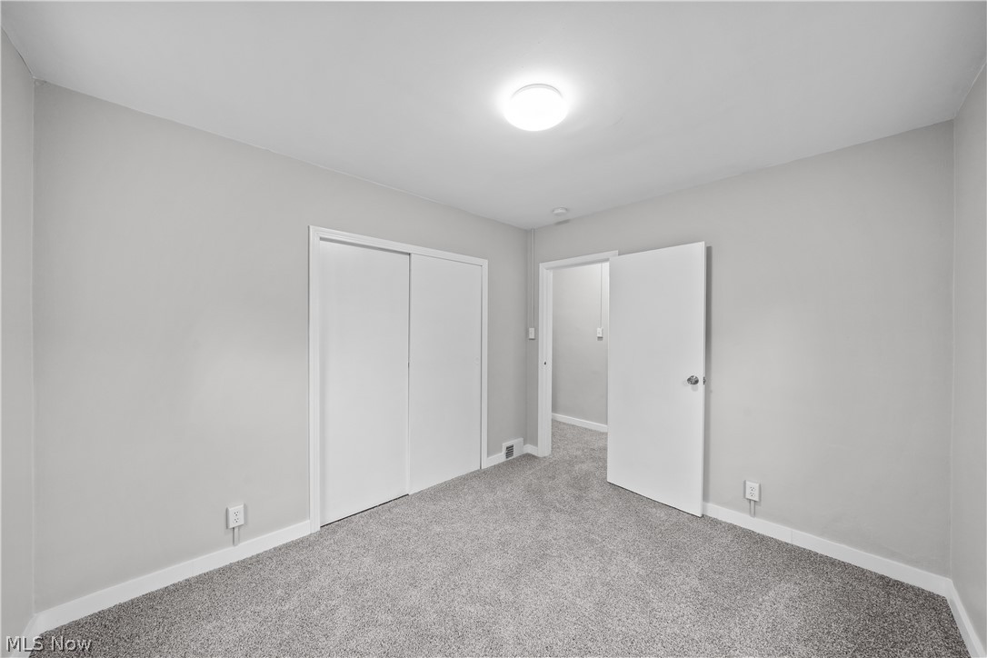 4814 Darrow Road Stow, OH 44224 - Photo 11 of 32 Unfurnished bedroom featuring light colored carpet and a closet
