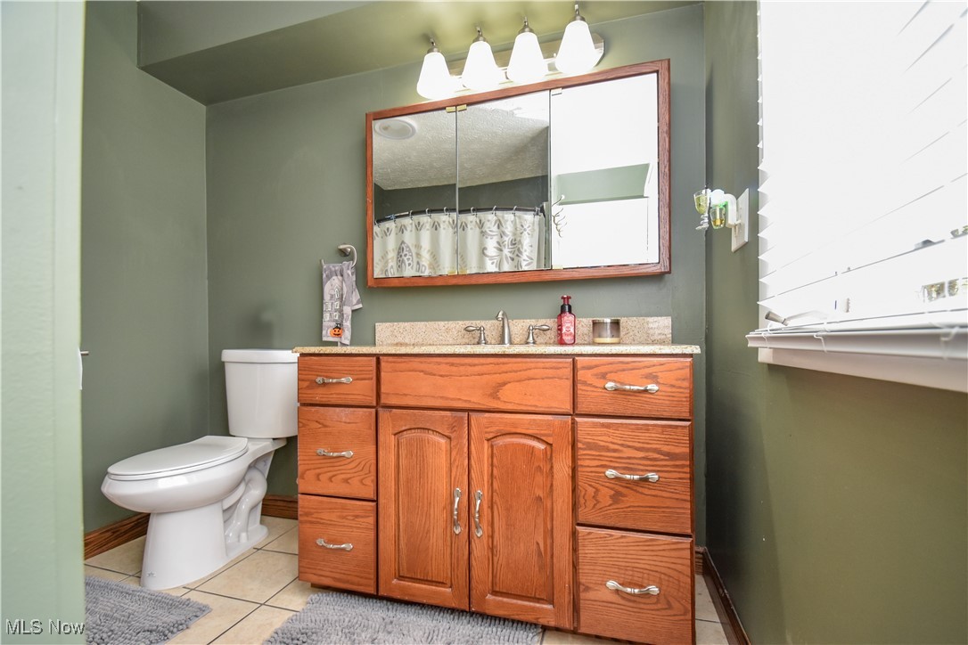 631 Carson Salt Springs Road Warren, OH 44481 - Photo 18 of 39 Bathroom with vanity, toilet, and tile patterned flooring