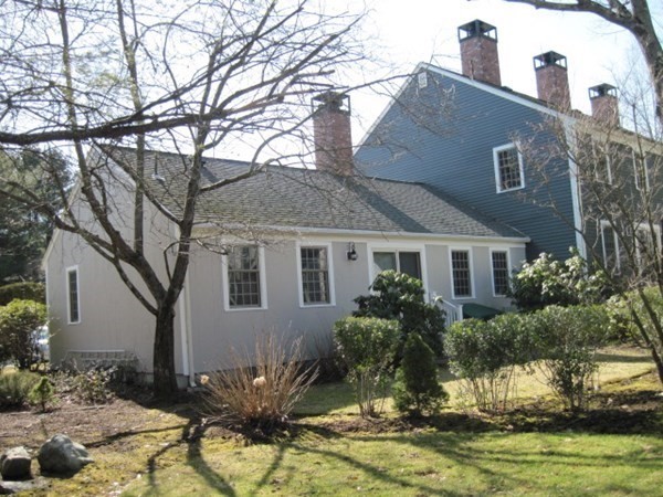 114 Jericho Road, Unit 114 Weston, MA 02493 - Photo 2 of 9 a front view of house with yard and trees around