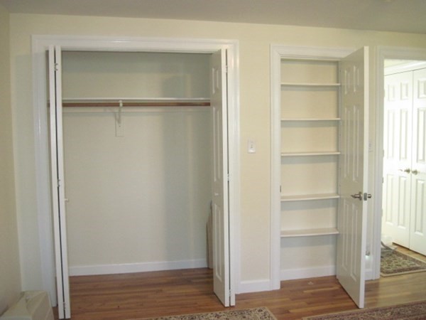 114 Jericho Road, Unit 114 Weston, MA 02493 - Photo 6 of 9 a view of an empty walk in closet with empty racks