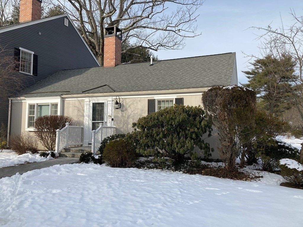 114 Jericho Road, Unit 114 Weston, MA 02493 - Photo 8 of 9 a view of a house with a yard covered in snow