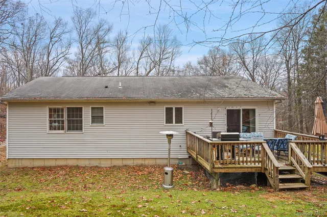 a view of house with roof deck and seating space