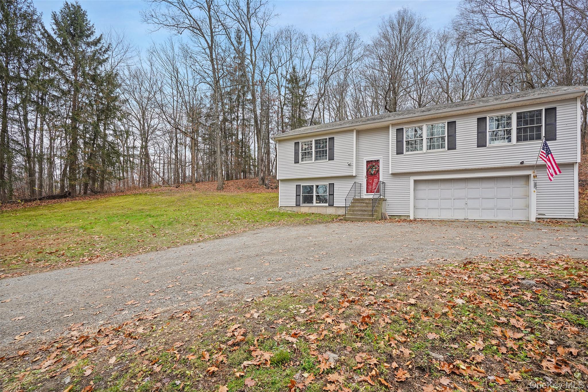272 Van Wyck Lake Road Fishkill, NY 12524 - Photo 2 of 25 a front view of a house with a yard and garage