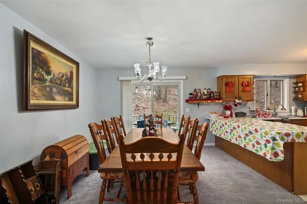 a view of a dining room with furniture and chandelier