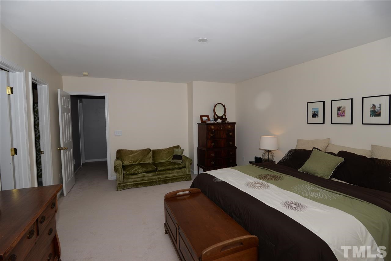 278 Inkster Cove Raleigh, NC 27603 - Photo 14 of 25 a bedroom with a bed and furniture