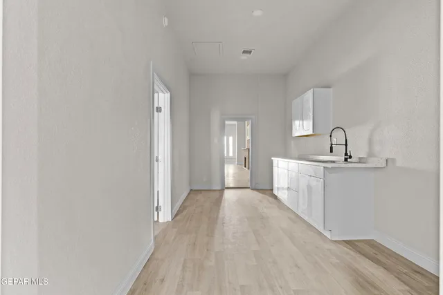 a view of a kitchen from the hallway