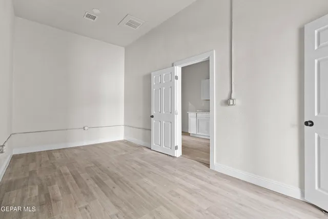 an empty room with wooden floor