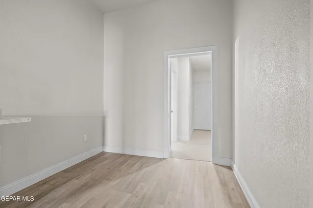 a view of an empty room and closet area