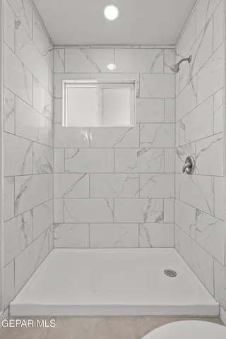 a bathroom with a bathtub and shower